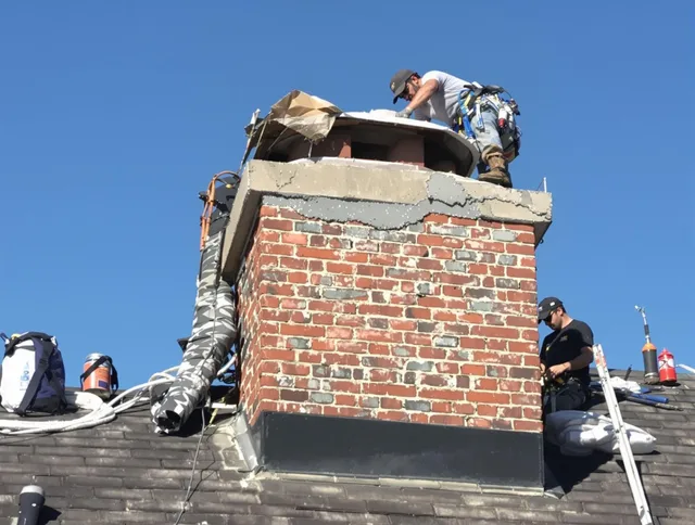 Holliston Chimney Sweep installing a custom chimney crown in Holliston, MA
