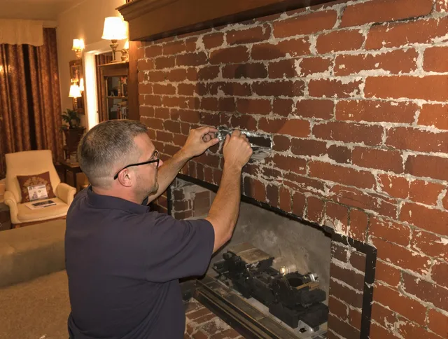 Holliston Chimney Sweep expert fixing a fireplace in Holliston, MA